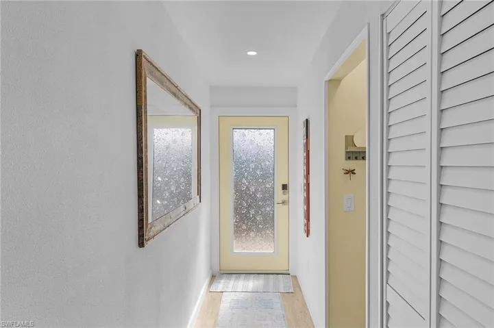 Entryway with light wood-type luxury vinyl flooring.