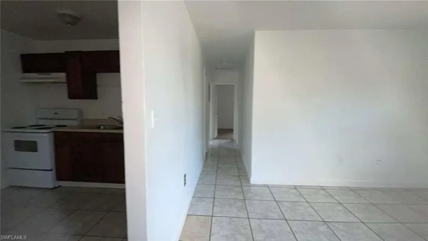 Hall featuring light tile patterned flooring