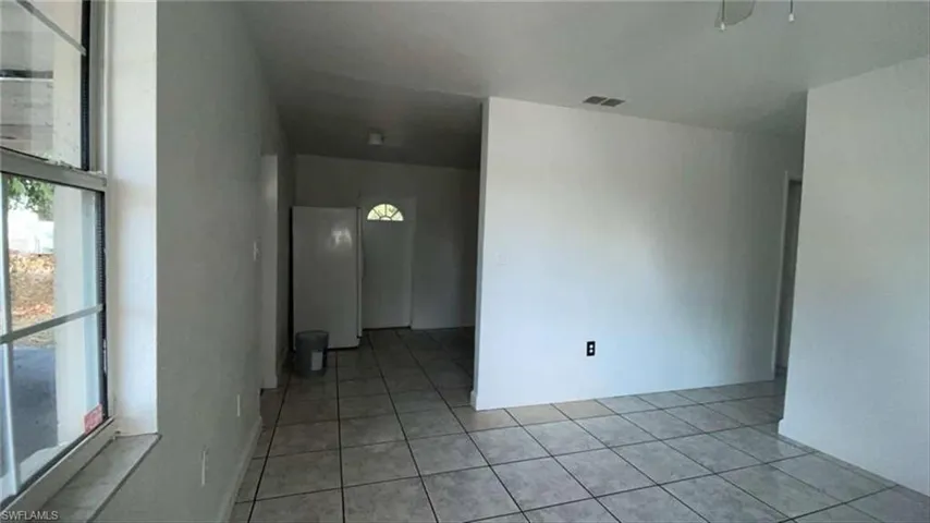 Spare room with light tile patterned flooring
