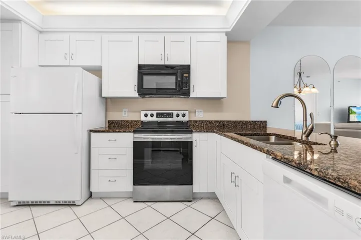 Updated kitchen w/Stainless Steel gooseneck faucet & soap dispenser, undermount SS sink, granite countertops, SS range. NO DOME! Contemporary light fixture.
