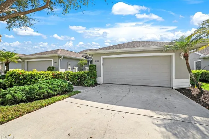 Single story home featuring a garage, driveway, and stucco siding