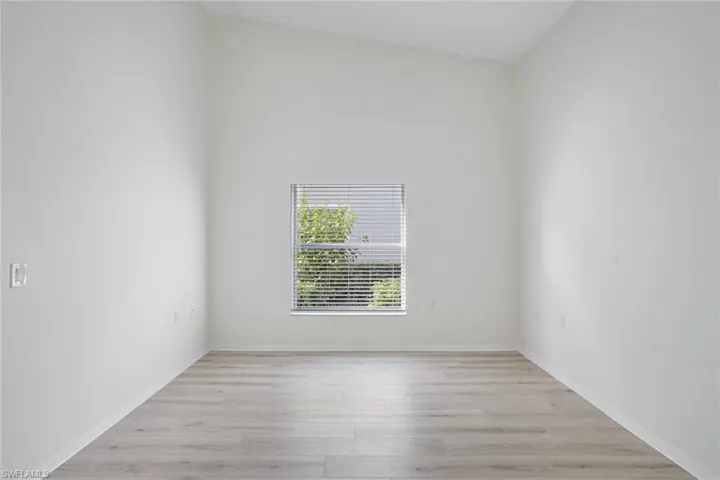 Unfurnished room with light wood-style floors and baseboards