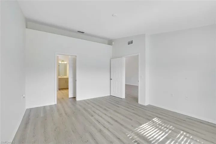 Unfurnished bedroom with light wood finished floors