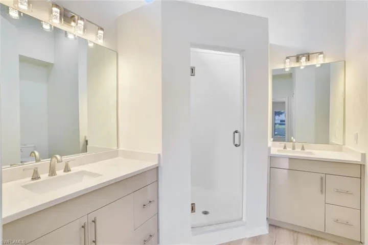 Bathroom with a shower stall and vanity
