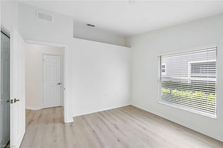 Empty room with light wood-style floors and baseboards