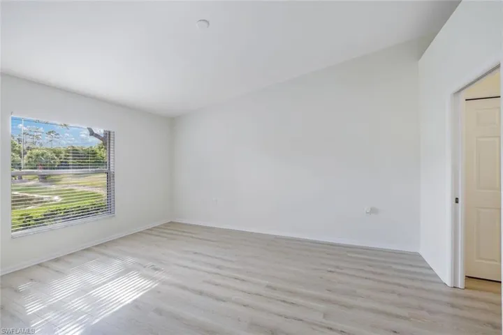 Unfurnished room with light wood-style floors and baseboards