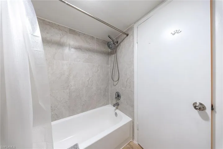 Bathroom with shower / bath combination with curtain