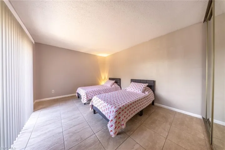 Bedroom featuring a textured ceiling and light tile patterned floors