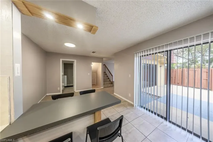 Dining room featuring light tile patterned flooring and a textured ceiling