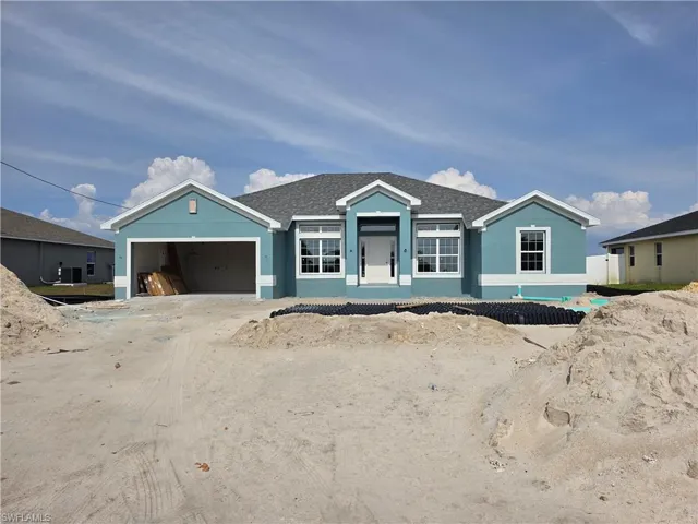 Single-story residence featuring a blue exterior with white trim accents and a gray shingle roof