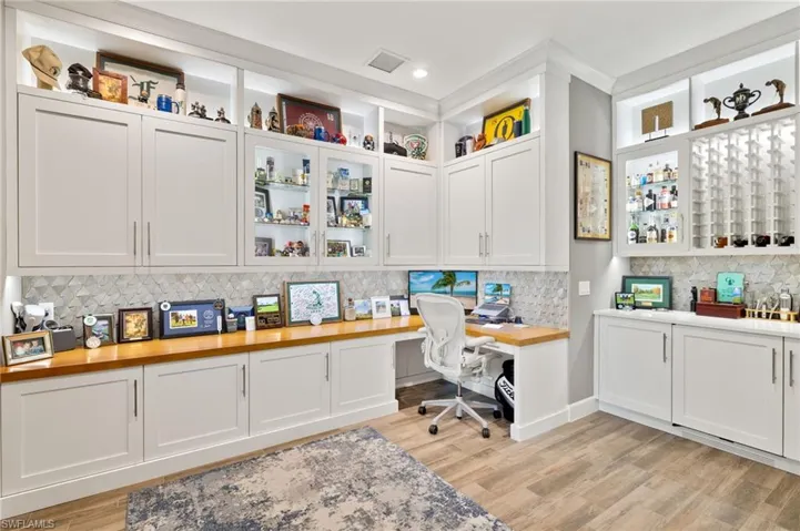 Office featuring built in desk and light wood-type flooring