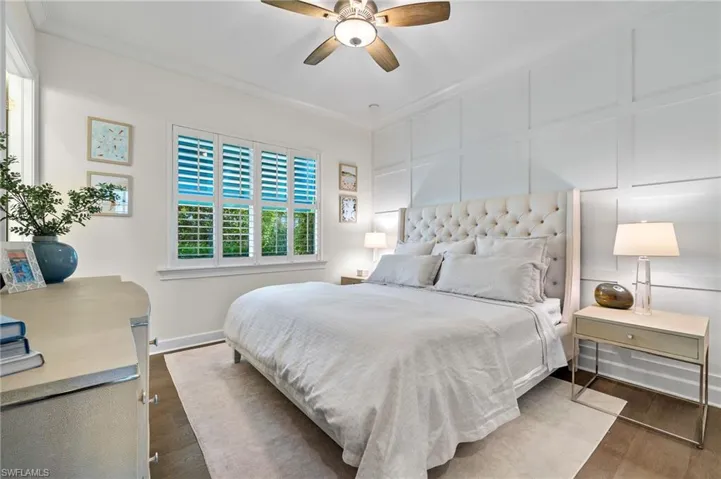 Bedroom featuring ornamental molding, ceiling fan, and dark hardwood / wood-style floors