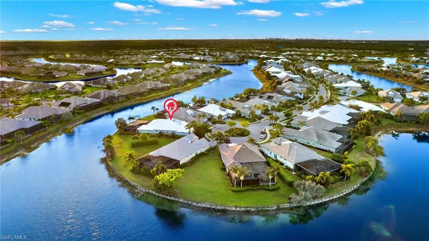 Birds eye view of property with a water view