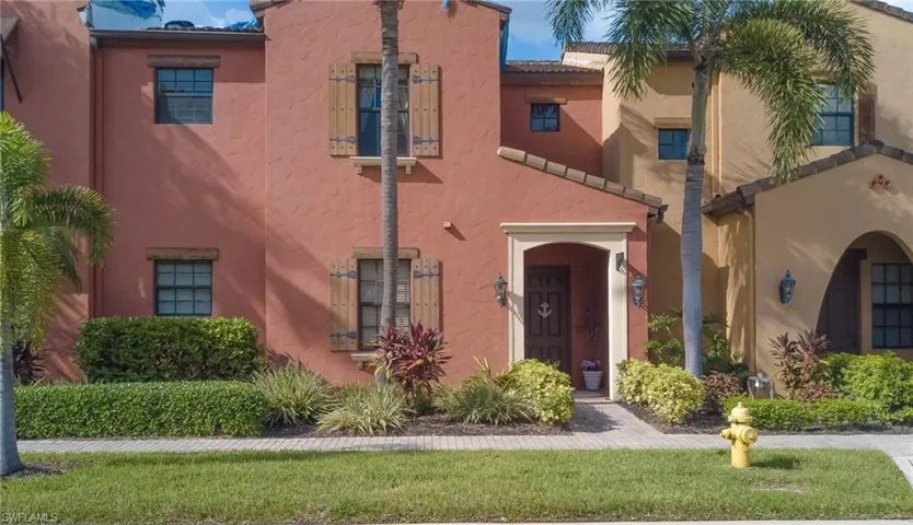 View of front of home with stucco siding and a front lawn
