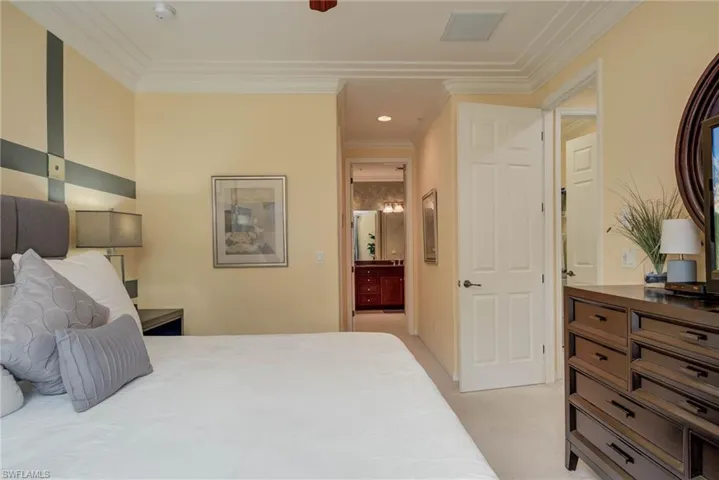 Bedroom featuring crown molding, light colored carpet, ensuite bathroom, recessed lighting, and ceiling fan