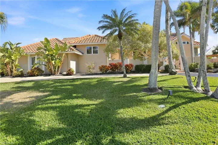 The Mediterranean-influence style ranch home sits on an elevated oversized lot.