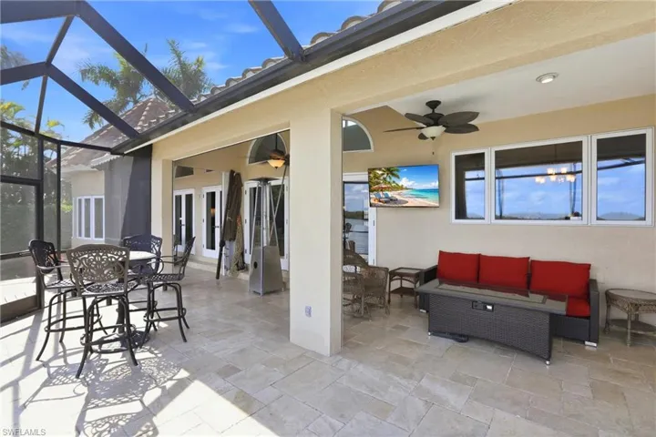 View of screened lanai with an outdoor living / dining area,
