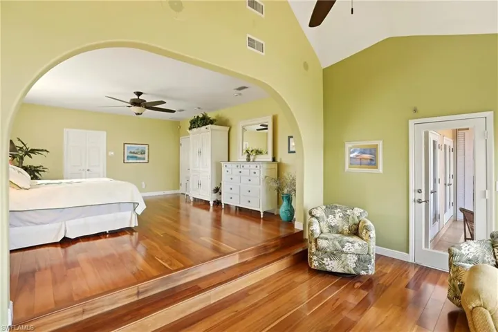The primary bedroom's sitting area opens to the screened lanai on the back of the home.