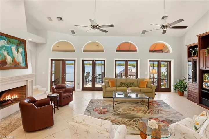French doors span the back of the spacious living room, providing endless, panoramic views of the bay.  The wood burning fireplace adds warmth on those occasional chilly Florida nights.