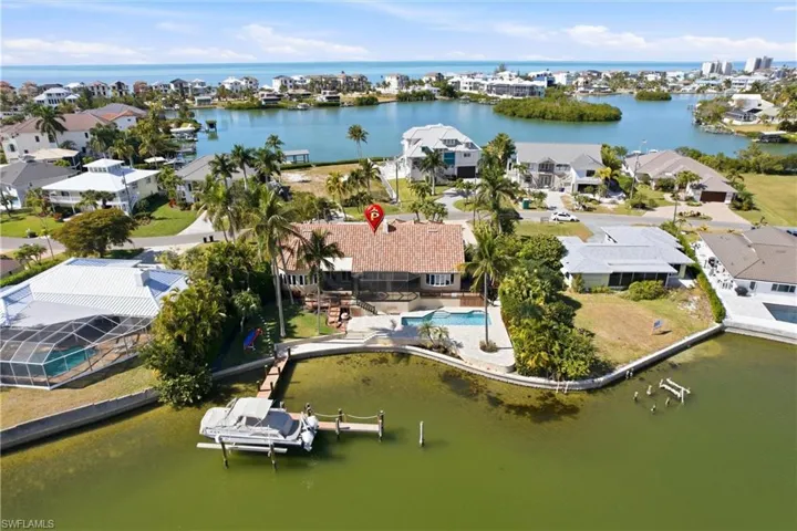 The home sits directly on an expansive bay, providing gulf access by boat just minutes away.  And beach access right up the street.