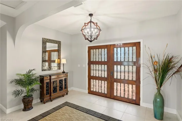 Massive wooden doors accent the entry way of the home.