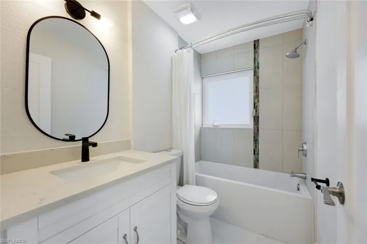 Guest bath features a gorgeous vanity, shower and soaking tub.