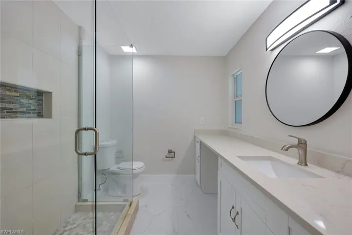 Primary ensuite bathroom features a stunning walk-in shower.