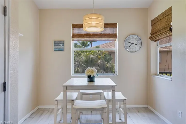 Breakfast nook with wood-finish flooring and neutral wall tones