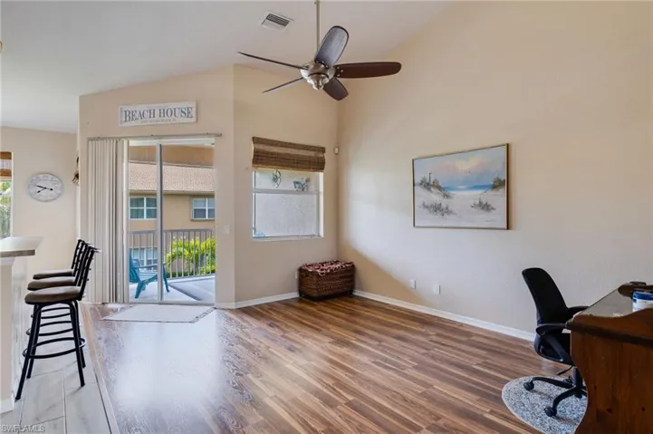Open living area featuring vaulted ceilings and wood-finish flooring
