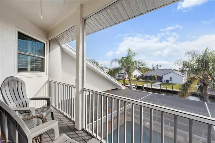Balcony featuring ceiling fan and a water view