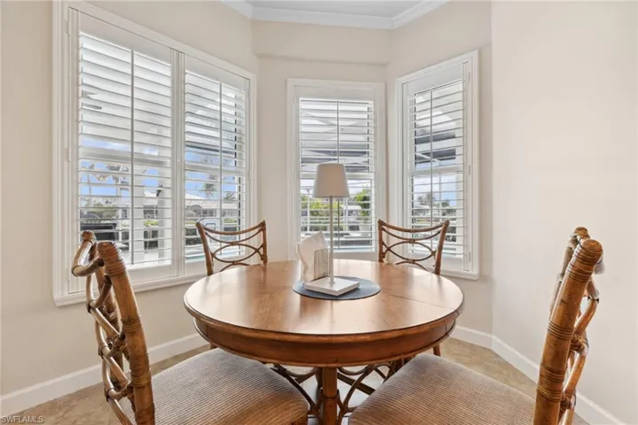 Dining space featuring crown molding and a healthy amount of sunlight