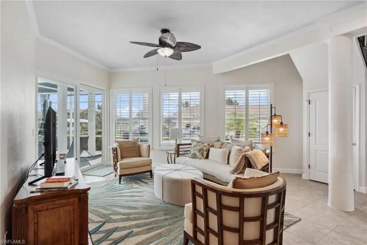 Sunroom / solarium featuring ceiling fan