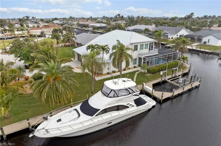 Birds eye view of property with a water view
