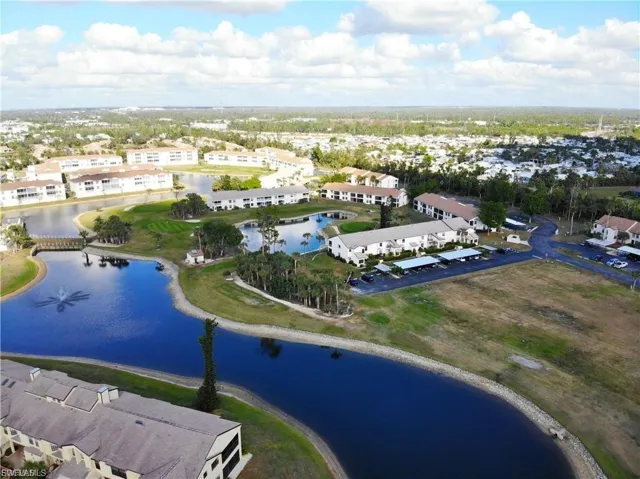 Aerial view of residential area featuring a large body of water