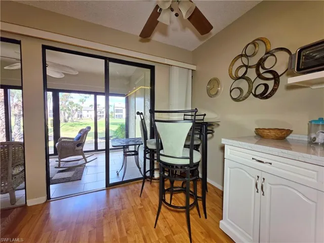 Dining room featuring a ceiling fan, a textured ceiling, and light wood-type flooring