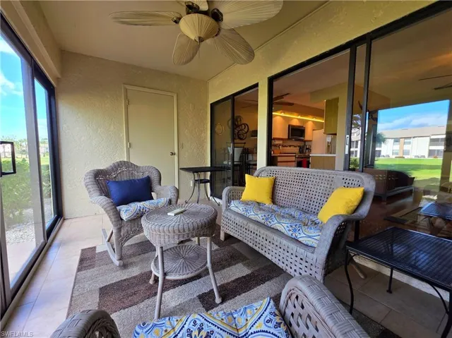 Sunroom / solarium with a textured wall and tile patterned floors