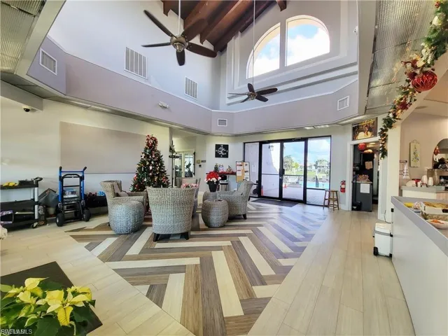 Common area with high vaulted ceiling and beam ceiling