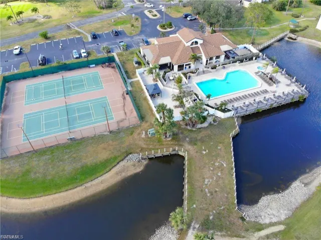 Aerial overview of property's location featuring a pool and a large body of water