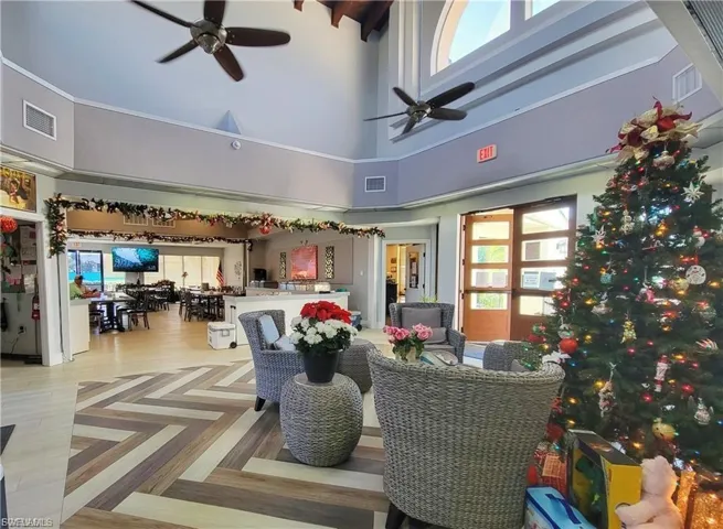 Living area with a towering ceiling and ceiling fan
