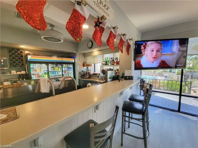 Community bar area featuring plenty of natural light and light countertops