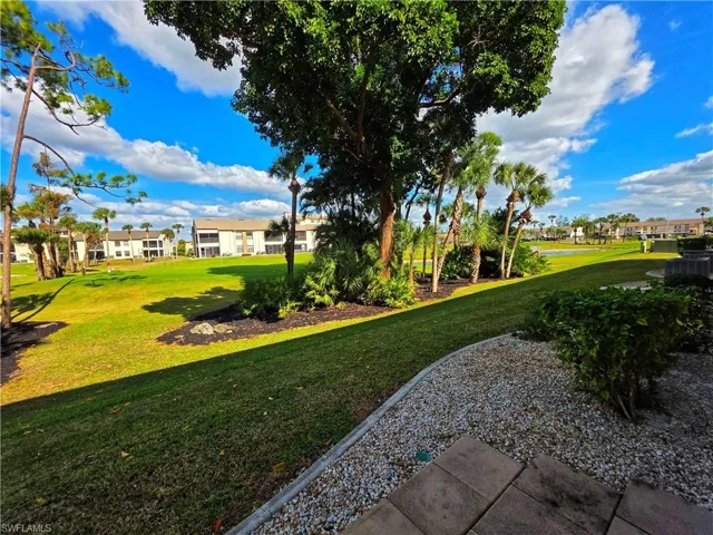 View of green lawn featuring a residential view