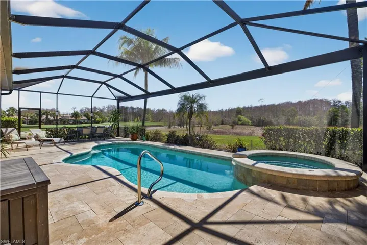 Integrated pool / hot tub featuring a sunroom, a patio area, and a lanai