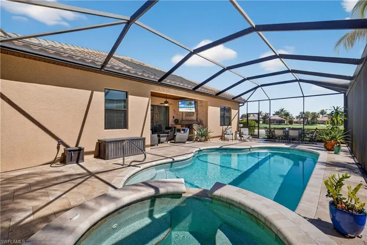 Integrated pool / hot tub with a sunroom, a patio, and a lanai
