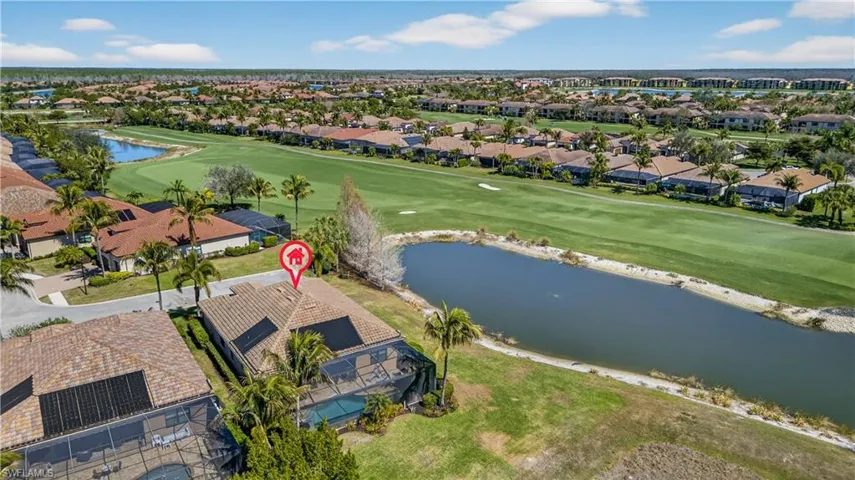 Aerial view of residential area with a large body of water and a golf club