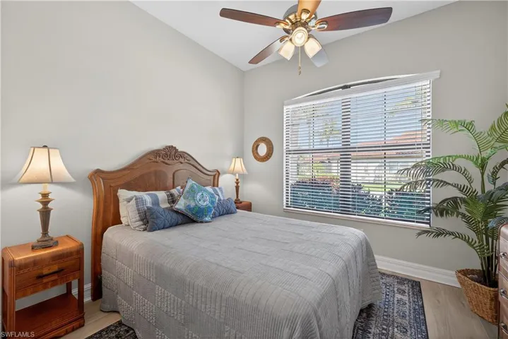 Bedroom with a ceiling fan and light wood-style floors