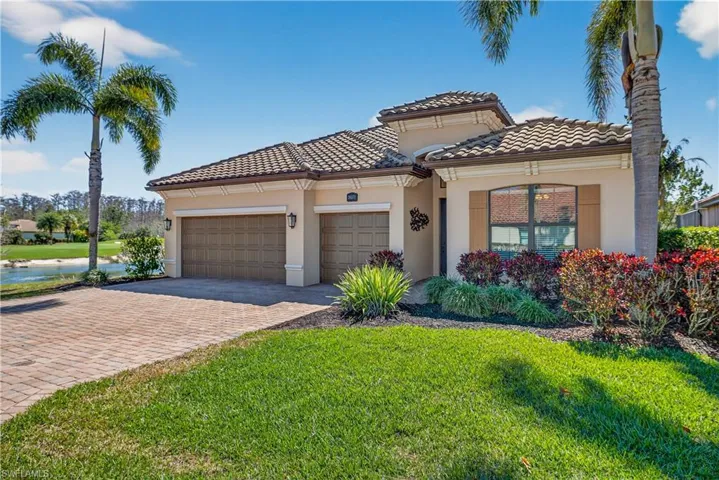 Mediterranean / spanish-style home with decorative driveway, stucco siding, an attached garage, and a front yard
