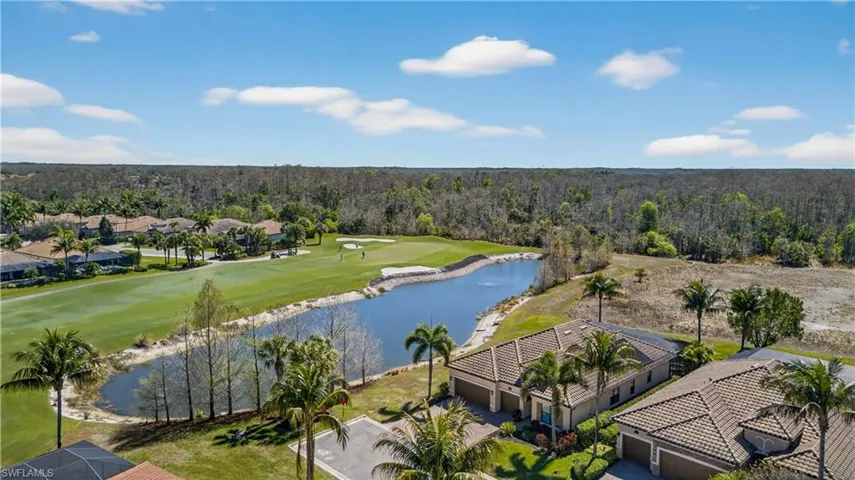 Aerial view of residential area with a nearby body of water and a golf course