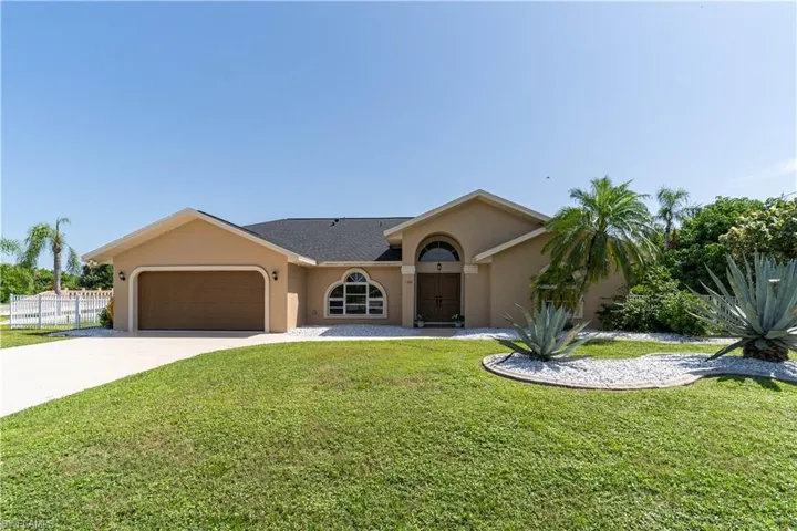 Single story home featuring a front lawn and a garage