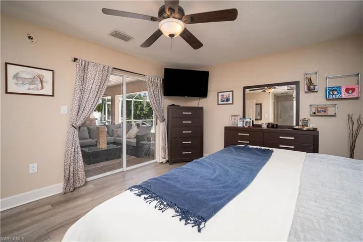 Bedroom featuring ceiling fan, access to outside, and hardwood / wood-style flooring