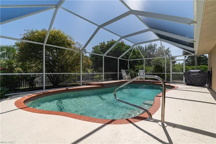 View of swimming pool with a patio and a lanai